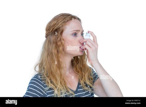 Pretty Blonde Using An Asthma Inhaler Stock Photo Alamy