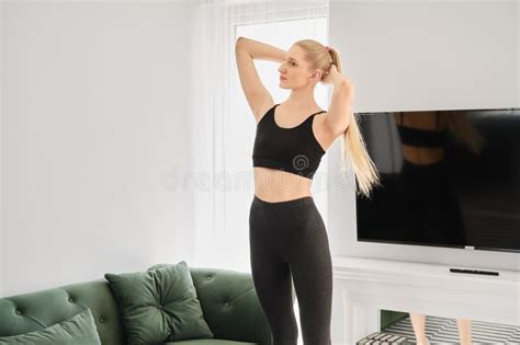 Active Blonde Woman Does Twisting Exercises At Home Stock Photo Image Of Active Energy 276650262