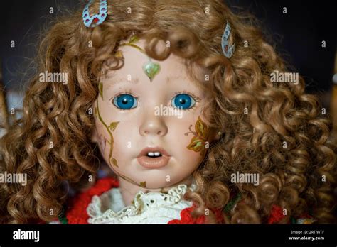 Realistic Porcelain Antique Vintage Girl Doll Or Toy Blonde Curly Hair And Vintage Dress Stock