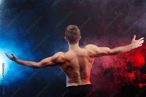 Muscular Handsome Man Bodybuilder With Naked Torso Posing On Smoke Background Studio Shoot