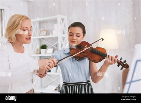 Attentive Blonde Female Teaching Her Student Stock Photo Alamy