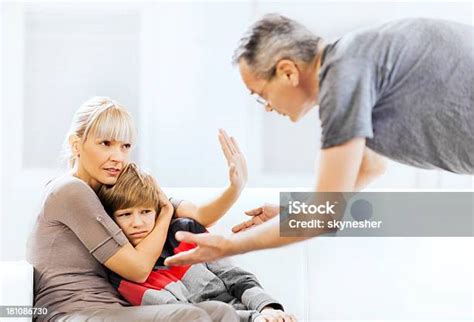 Mother Defending Her Son While Father Is Scolding Him Stock Photo