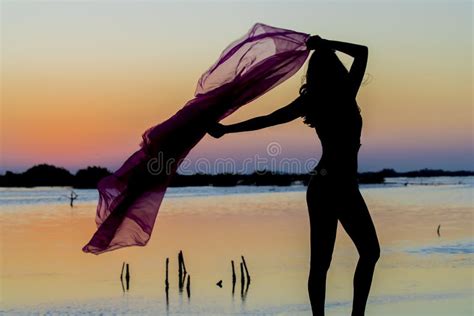 Hispanic Brunette Model Enjoying An Early Morning Sunrise Stock Photo