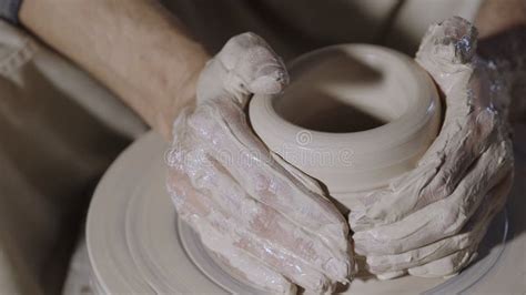 Wet Male Potter S Hands Sculpting Soft Clay And Shaping The Pot On