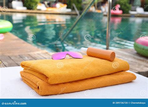 Beach Towels Sunglasses And Sunscreen On Sun Lounger Near Outdoor