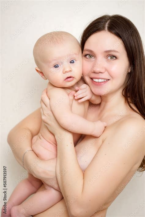 Beautiful And Gentle Naked Mom And Baby Against The Wall Stock Photo Adobe Stock