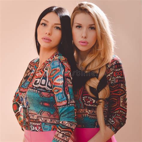 Beautiful Blonde And Brunette Girls Standing Together Stock Photo