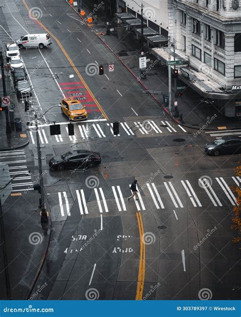 Deserted Urban Street Lined with Traffic Lights and a Few People