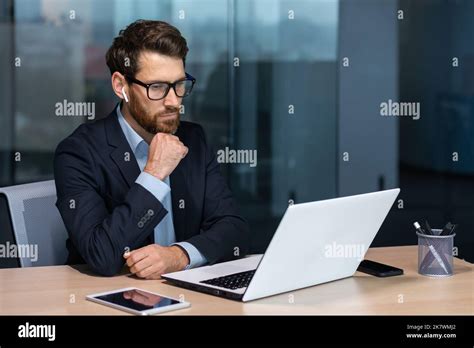 Serious Thinking Mature Businessman Working Inside Modern Office