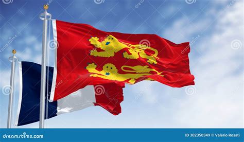Flags Of Normandy And France Waving In The Wind On A Clear Day Stock