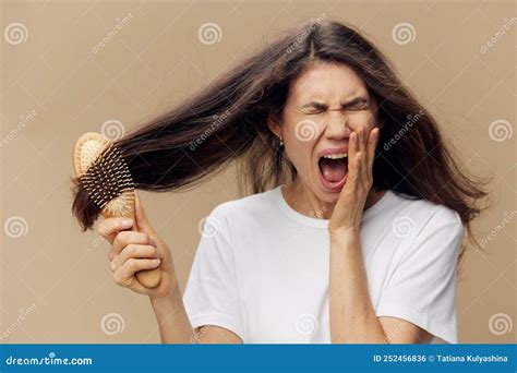 Beautiful Cute Attractive Middle Aged Brunette Combing Her Long Hair With A Wooden Comb While
