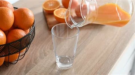 Man Pouring Orange Juice Into A Glass In Stock Video Pond5