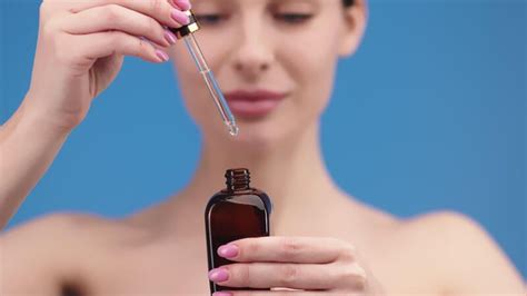 closeup woman applying facial serum  dropper caring  skin