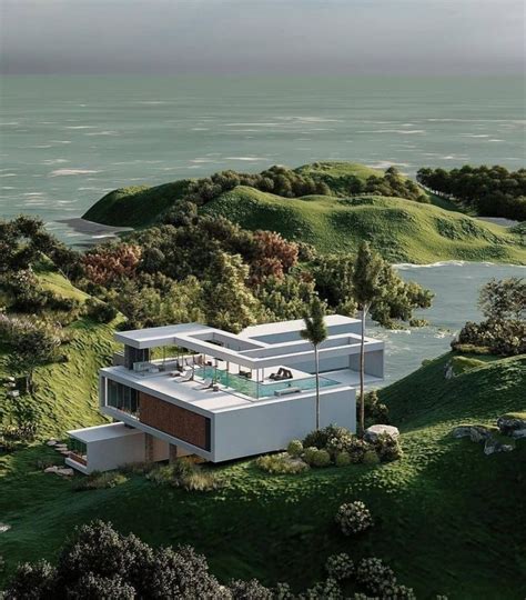 An Aerial View Of A House In The Middle Of Some Green Hills With Water