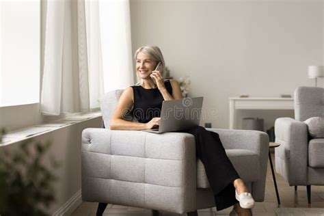 Positive Successful Mature Speaking On Cellphone At Home Stock Photo Image Of Businesswoman
