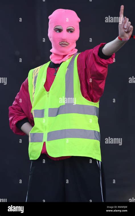 A Band Member Of Pussy Riot Is Shown Performing On Stage During A Live Concert Appearance