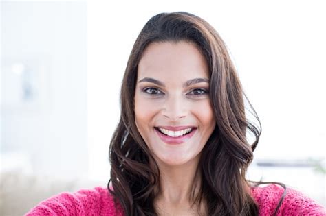 Premium Photo Smiling Beautiful Brunette Relaxing On The Couch And Looking At Camera