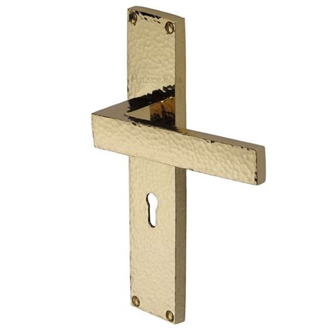 Heritage Delta Hammered Lock Door Handles Polished Brass Lacquered Broughtons Lighting