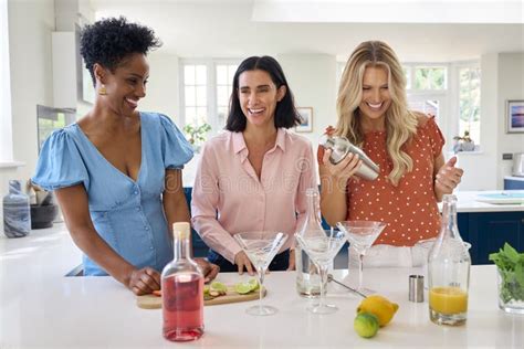 Three Mature Female Friends At Home Having Fun Mixing Cocktails Together Stock Photo Image Of