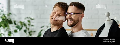 Two Men Members Of A Gay Couple Stand Side By Side In A Designer Workshop Collaborating On