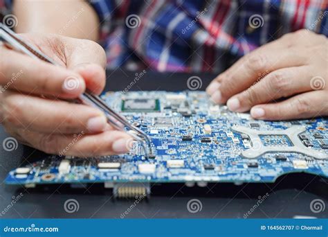 Technician Repairing Inside Of Hard Disk By Soldering Iron Stock Image