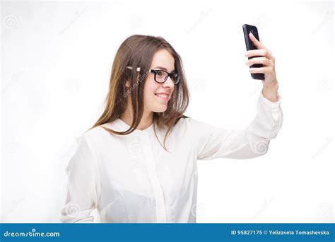 Beautiful Girl In Glasses And A White Shirt Takes A Picture Of Herself On The Camera Phone