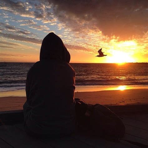 Back View Of Person Sitting On The Beach And Watching The Sunset Beach Watch Person Sitting