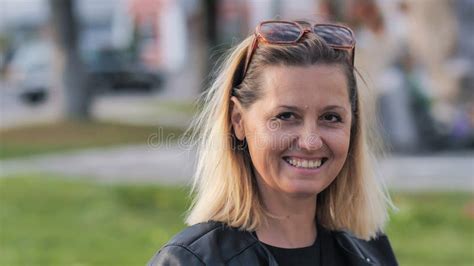 Stunning Blonde Woman Is Smiling Outside On A Sunny Day In A City Setting Stock Image Image Of