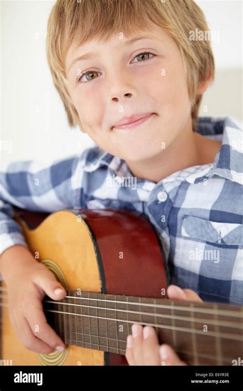 Young boy playing acoustic guitar Stock Photo - Alamy