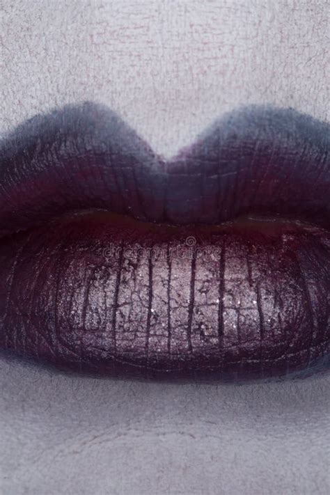 Close Up Of Beautiful Full Woman Lips With Purple Makeup Stock Photo