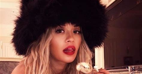 Rita Ora Strips Totally Nude Apart From Fur Hat As She Seductively Tucks Into Cream Cake In New