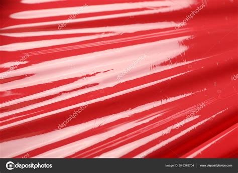 red plastic stretch wrap background closeup stock photo  cnewafrica