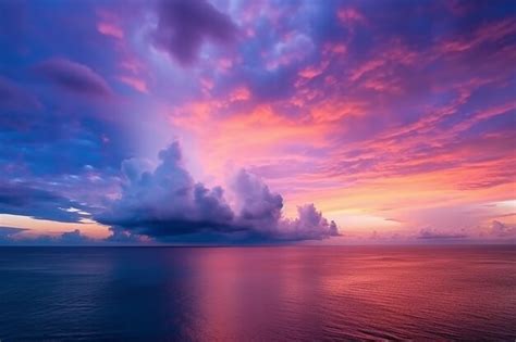 Premium AI Image | A colorful sunset over the ocean with a purple and ...