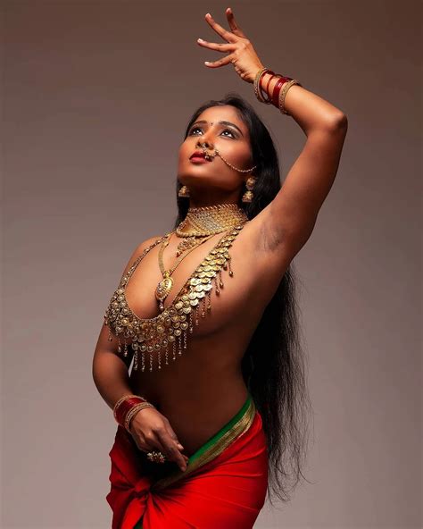 Desi MILF Model Poses Fully Nude While Sitting On Bed Showing Her Petite Boobs And Shaved Pussy