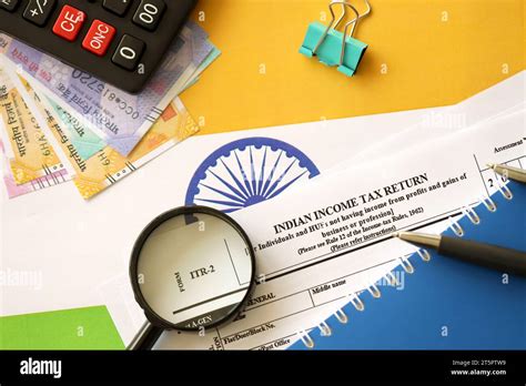 Indian Income Tax Return Blank Form With Pen And Indian Rupees Bills On