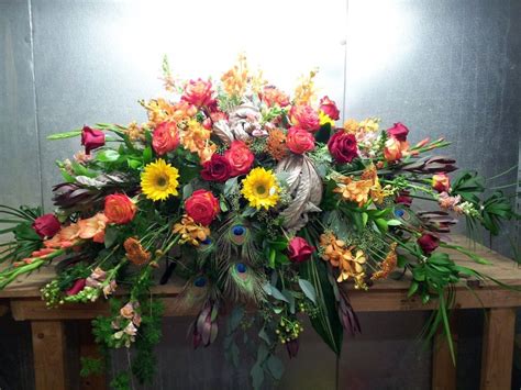 Masculine Flowers And Materials Compose This Casket Spray For The