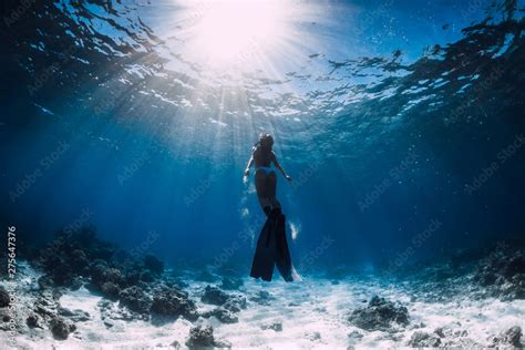 Free Diver Girl In Bikini Over Sandy Sea Glides With Fins Stock Photo Adobe Stock