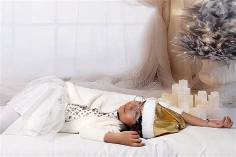 5 Year Old Latina Girl With Eyeglasses Among Decorated Trees Is Excited To Celebrate Christmas