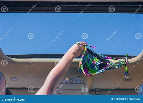 Girl Trowing Away Her Bikini Bra Out From Open Hatch Of A Vehicle