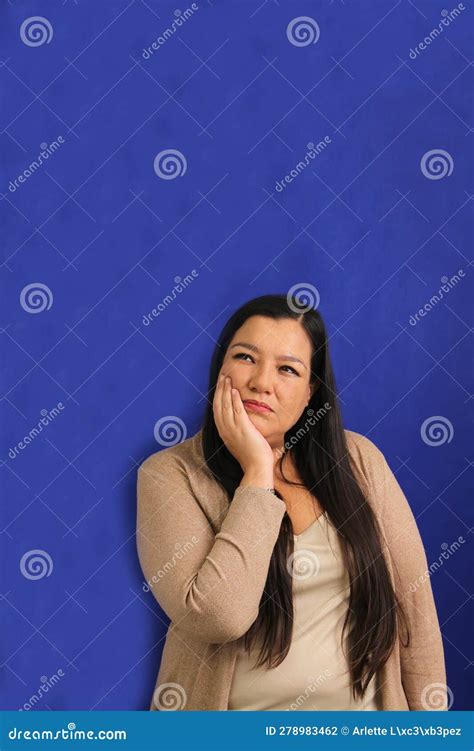 Adult 40 Year Old Latina Woman Suffers Pain In Her Teeth Due To Cavities And Gingivitis She