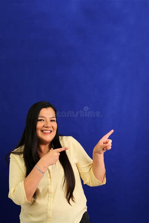 40 Year Old Latina Woman Points To Something That She Likes Surprises And Excites Such As