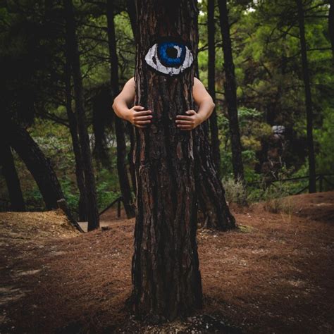 Premium Photo Woman Photographing Tree Trunk In Forest