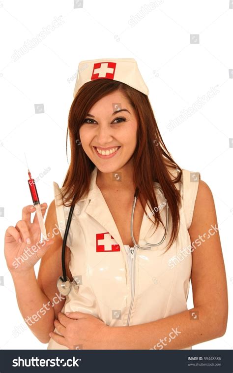 Beautiful Brunette Nurse With Gorgeous Smile And Holding A Syringe Stock Photo