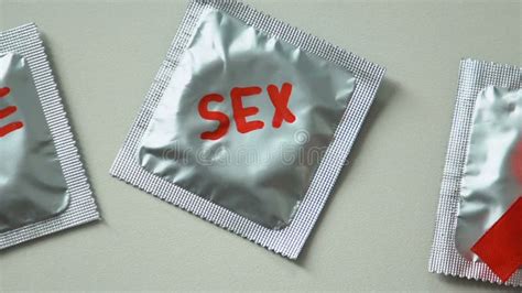 Safe Sex Words Written On Condoms Red Ribbon As HIV AIDS Awareness Prevention Stock Footage