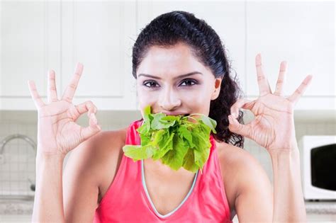 Premium Photo Woman With Ok Sign And Spinach In Kitchen