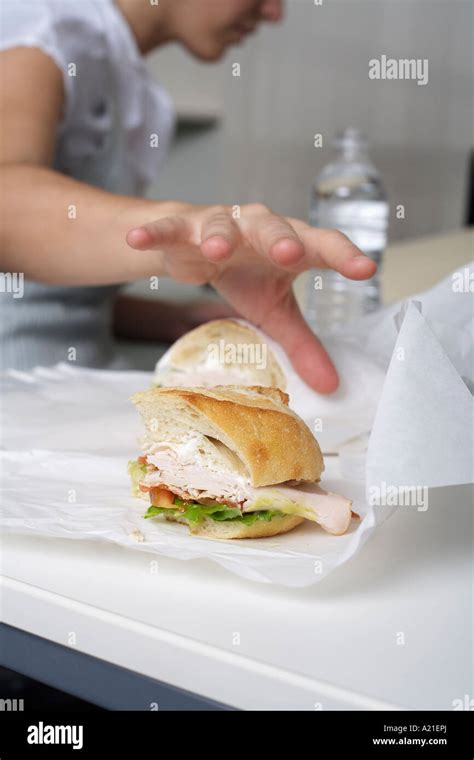 Businesswoman Eating At Desk Stock Photo Alamy