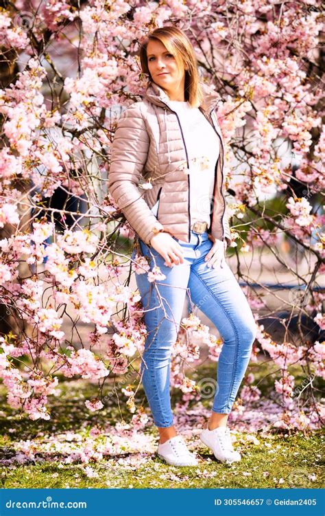 Woman With Brunette Short Hair With Streaks In Jeans And Quilted Vest