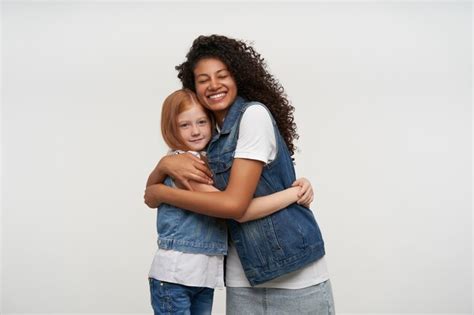 Free Photo Portrait Of Happy Dark Skinned Brunette Woman Hugging Carefully Pretty Lond Haired