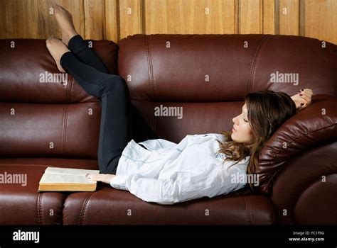 Sleeping Girl With A Book On The Couch Stock Photo Alamy