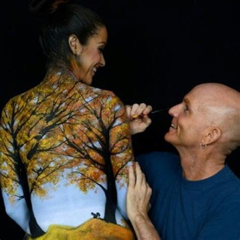 A Man Is Painting The Back Of A Woman S Body With Trees On It